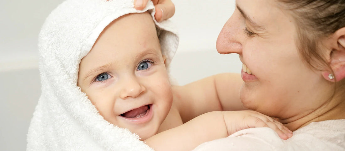 Safe shower with baby guide showing gentle handheld shower head technique